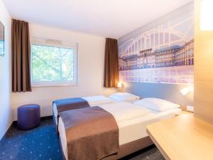 Voodi või voodid majutusasutuse B&B Hotel Mannheim-Neuostheim toas