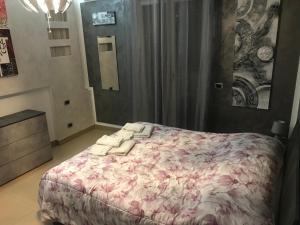 a bedroom with a large bed with a pink blanket at La casa di Elena in Sannicandro di Bari