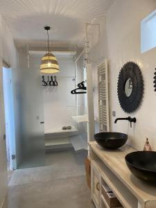 a bathroom with two sinks and a mirror at 3 Paros *All Season* Villas in Parikia