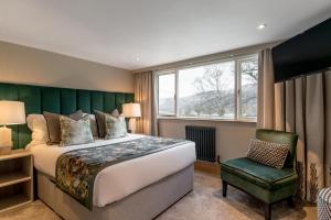 A bed or beds in a room at Borrowdale Gates Hotel