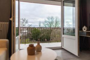 a room with a glass door leading to a balcony at Appartement Les Oiseaux in Thionville