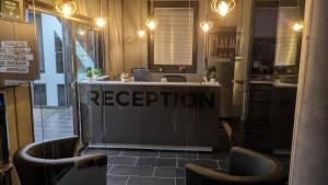 a reception desk with two chairs in a restaurant at Business-Motel, free XL-Parking, WiFi, massage-chairs, sauna, shared kitchen, breakfast 2go, free soda, coffee in Heimsheim