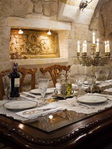 a table with plates and glasses and candles on it at Sacred House in Urgup