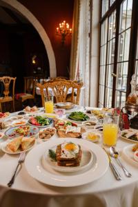 a table with plates of food and drinks on it at Sacred House in Urgup