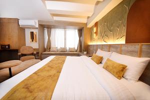 Cama ou camas em um quarto em Daali Hotel & Apartment