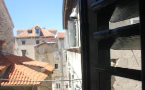 a view of a city from a window at Slavija Culture Heritage Hotel in Split