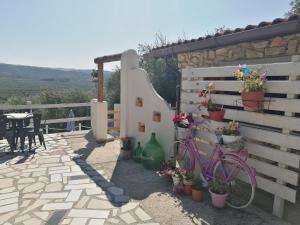 uma bicicleta rosa estacionada ao lado de uma parede com flores em B&B Borgo Degli Ulivi em Vieste