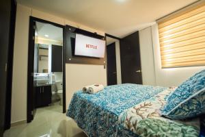 A bed or beds in a room at Apartamentos Amoblados Confort Turismo en Cúcuta