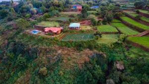 una vista aérea de una casa de campo en una colina en Lifeline Villas - Miracle 5BHK Infinity Pool Villa With Breathtaking Valley View And Huge Lawn Area, en Mahabaleshwar