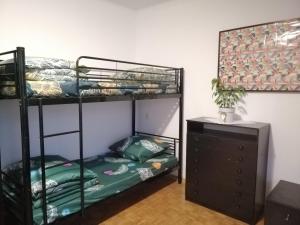 a room with two bunk beds and a dresser at Ewa Dom in Warsaw