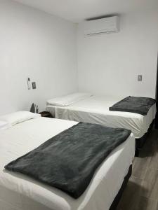 Tempat tidur dalam kamar di Hospedajes Nuñez Tequila