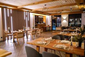 une salle à manger avec des tables et des chaises en bois dans l'établissement Yo Hotel, à Bukovel