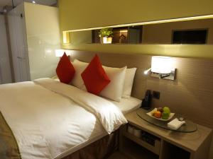 Cama ou camas em um quarto em Kaohsiung International Plaza