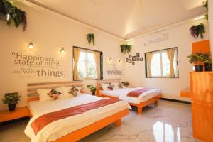 A bed or beds in a room at Cherryleen Resort Nagaon