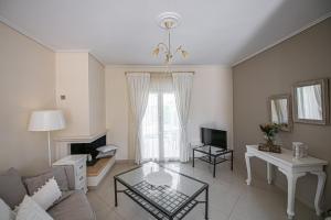 a living room with a couch and a table at Nereides Luxury Villas in Káto Almirí