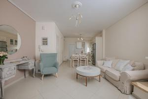 a living room with a couch and a table at Nereides Luxury Villas in Káto Almirí