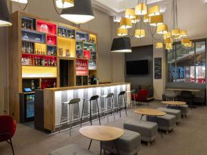 a bar with chairs and tables in a restaurant at ibis Lyon Centre Perrache in Lyon