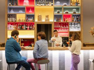 a group of people sitting at a bar at ibis Lyon Centre Perrache in Lyon