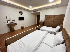 Una cama o camas en una habitación de Soulmate Hotel Erbil