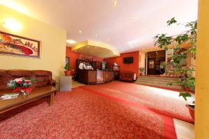 a living room with a couch and a table at Hotel Premier in Cluj-Napoca