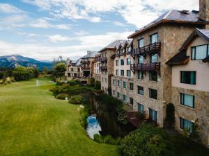 an aerial view of a resort with a river and buildings at Loi Suites Chapelco Hotel in San Martín de los Andes