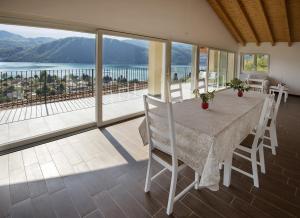 una sala da pranzo con tavolo e vista sull'oceano di B&B Il Barsot a Pettenasco