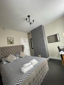 een slaapkamer met een bed met twee handdoeken erop bij Burton Villa Guest House in York