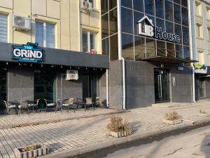 a building with chairs and tables in front of it at Moldova Balți center in Bălţi