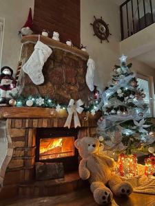 een kerstboom in een woonkamer met een open haard bij Vila Impresija Fruska gora in Novi Sad