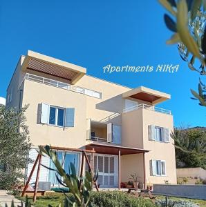 a view of a house with a blue sky at Apartmani NIKA in Dubrovnik