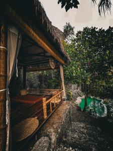 a building with a roof with a bed in it at Trang An Lamia Bungalow in Ninh Binh