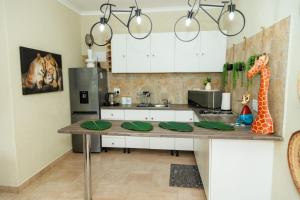 a kitchen with a table with a giraffe on it at Pumbaa Wildlife Park & Accommodation in Nelspruit