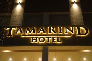 a sign on top of a trumpeland hotel at night at HOTEL Tamarind in Mohali