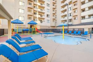 - une piscine avec des chaises et une aire de jeux dans un bâtiment dans l'établissement Hilton Vacation Club Polo Towers Las Vegas, à Las Vegas