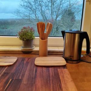 a kitchen counter with a coffee pot and wooden cutting boards at Gästewohnung von J&O am Fluss. in Jork