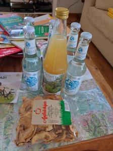 a table with bottles of drinks and some food at Gästewohnung von J&O am Fluss. in Jork