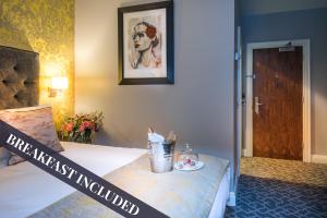 a hotel room with a bed with a breakfast included at Shipquay Boutique Hotel in Derry Londonderry