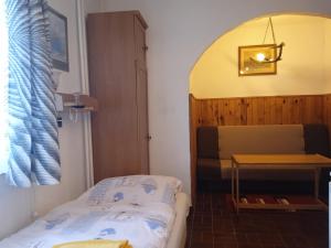 a small bedroom with a bed and a table at Penzion Kalina in Tábor