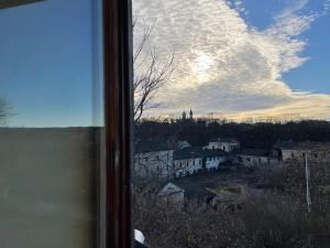 a view of a city from a window at Tisnyi 7 Guest House in Kamianets-Podilskyi