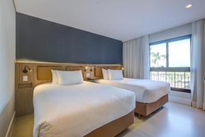 Rúm í herbergi á Hilton Garden Inn São José do Rio Preto