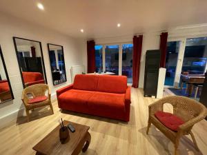 a living room with an orange couch and chairs at Flat vane & Soun in Waterloo