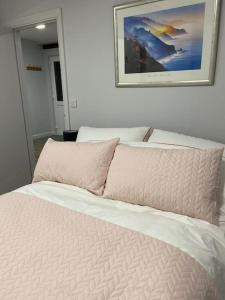 a bed in a bedroom with a picture on the wall at The Old Barn one bedroom apartment in Overton in Overton