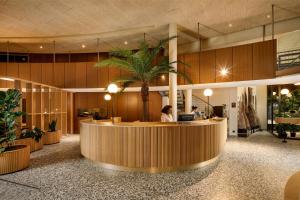 eine Lobby mit einer Rezeption und einer Palme in der Unterkunft Palmiers by Fassbind in Lausanne