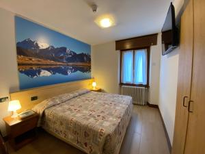 Кровать или кровати в номере Hotel Sciatori 3 Stelle Superior