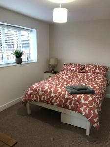 a bedroom with a bed with a comforter and a window at Springwood farm 