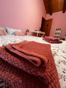 a bedroom with a red blanket on a bed at C'era una volta in Castelnuovo Don Bosco