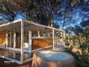 a house with a hot tub on a deck at FALCOARIA de Santa Efigenia in Setúbal