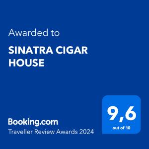 un panneau bleu avec le texte attribué à la santa clara ciger house dans l'établissement SINATRA CIGAR HOUSE, à Banská Bystrica