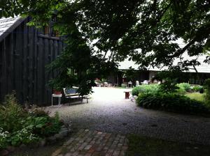 a patio with a bench in a garden at Chill Inn in Bernāti