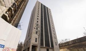 a tall building in front of a building at Hotel Mayotte in Uiwang